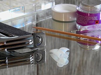 Nail Art Tools and Gel Polish on Glass Table