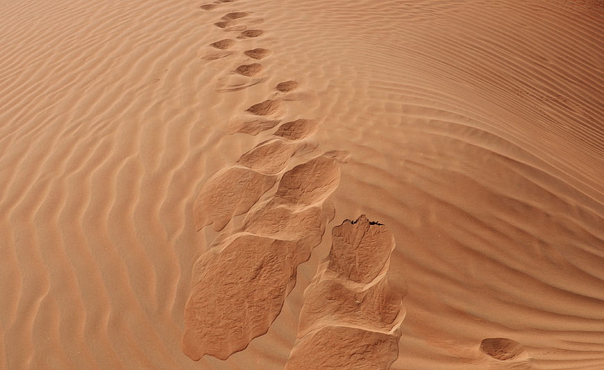 Footprints in rippled desert sand dunes