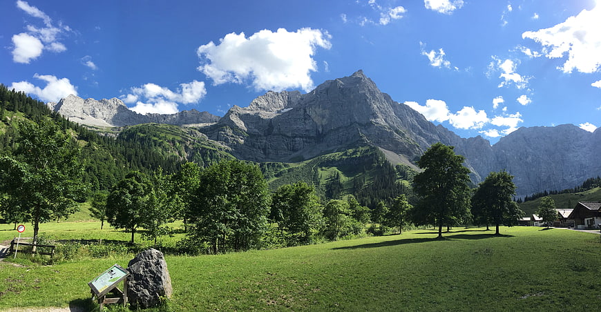 Panoramic Alpine Landscape with Green Meadow and Mountains