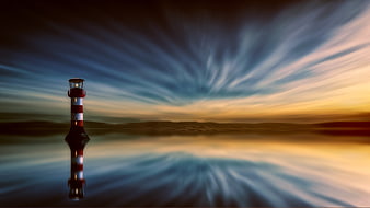 Dramatic Lighthouse with Streaked Sky and Reflection