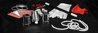 Magician props and magic tricks on black background