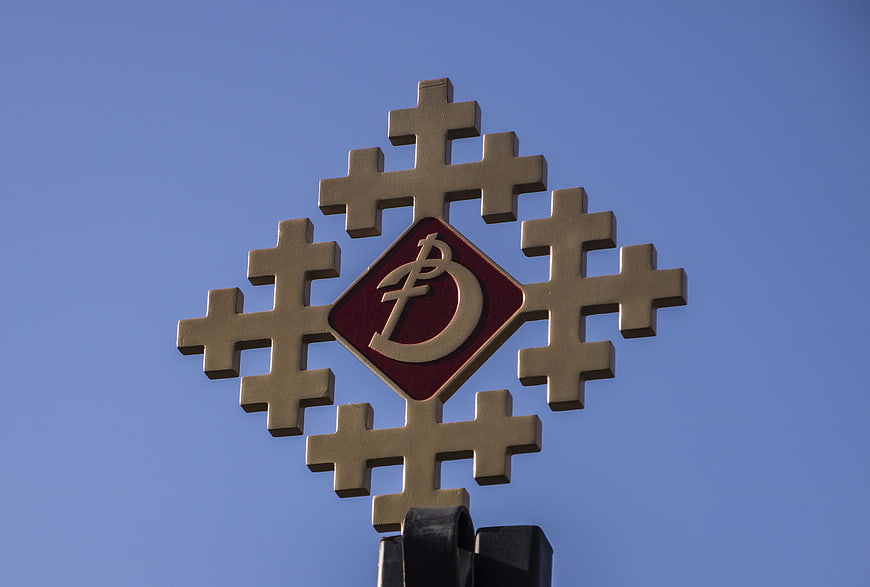 Orthodox Cross with Bishop Emblem Against Blue Sky