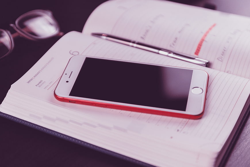 Smartphone on Planner with Pen and Glasses