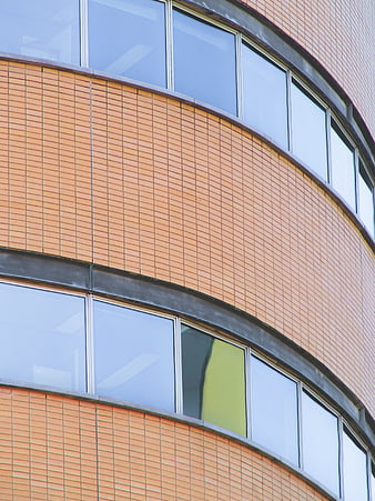 Curved Orange Brick Building Facade with Windows