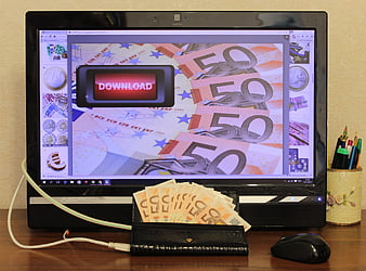 Concept of online finance with euro banknotes and a computer monitor