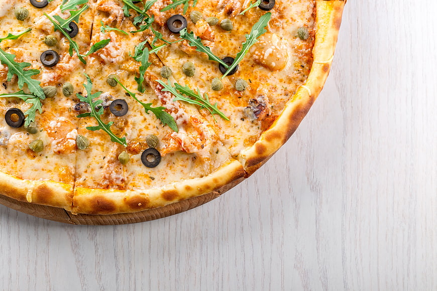 Top View of Gourmet Pizza with Arugula and Olives