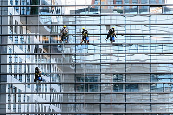 Window Cleaners on Modern Glass Skyscraper Facade