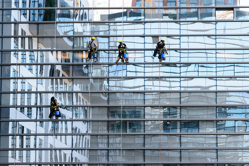Window Cleaners on Modern Glass Skyscraper Facade