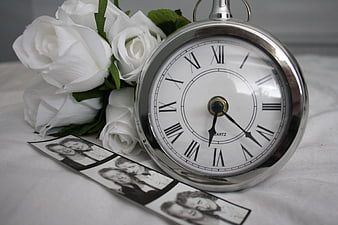 Vintage pocket watch with white roses and photo strip