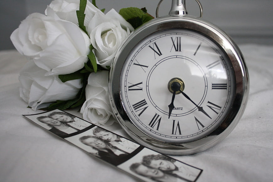 Vintage pocket watch with white roses and photo strip