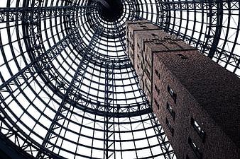 Low angle view of brick tower inside glass dome
