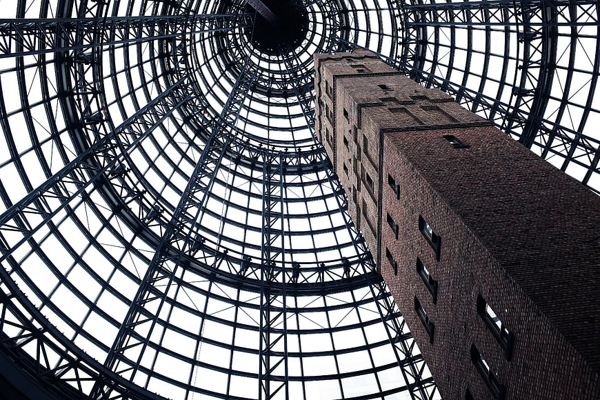 Low angle view of brick tower inside glass dome