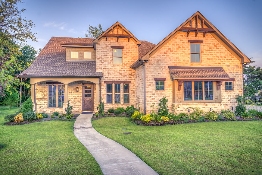 Luxury Stone House Exterior With Landscaped Front Yard