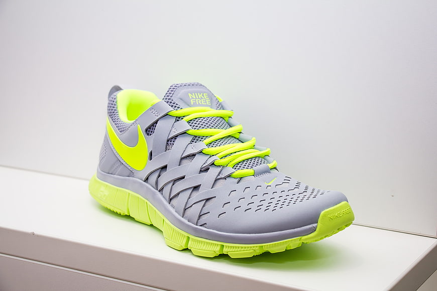 Gray and Neon Green Nike Free Running Shoe on White Surface