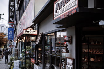 Korean Street Cafe with Pie Shop Signage and Pedestrians