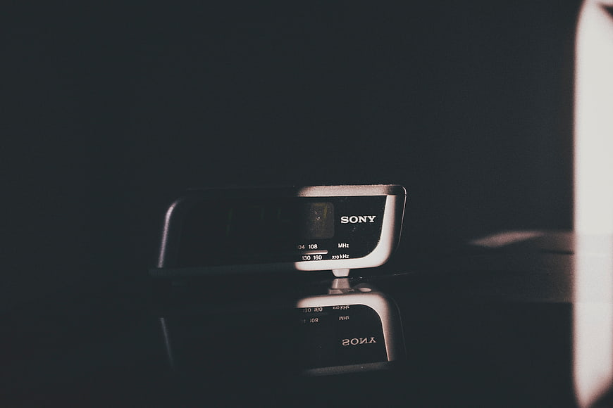 Vintage Sony Radio on Reflective Surface in Dark Room