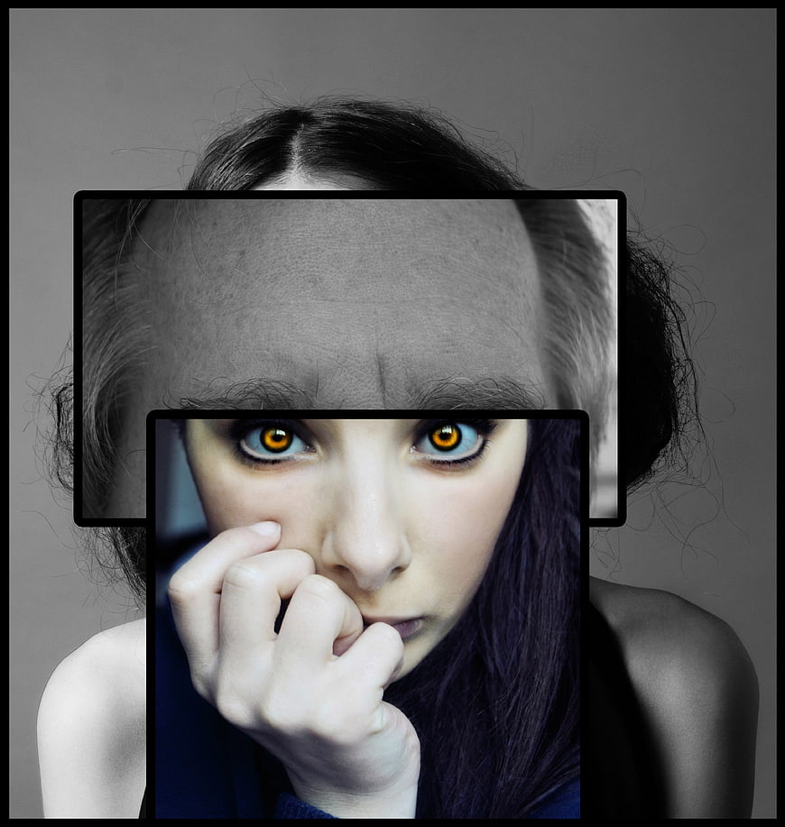 Conceptual portrait of woman with split identity and intense eyes