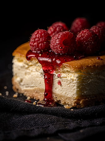 Close-up of Raspberry Cheesecake Slice with Dripping Sauce