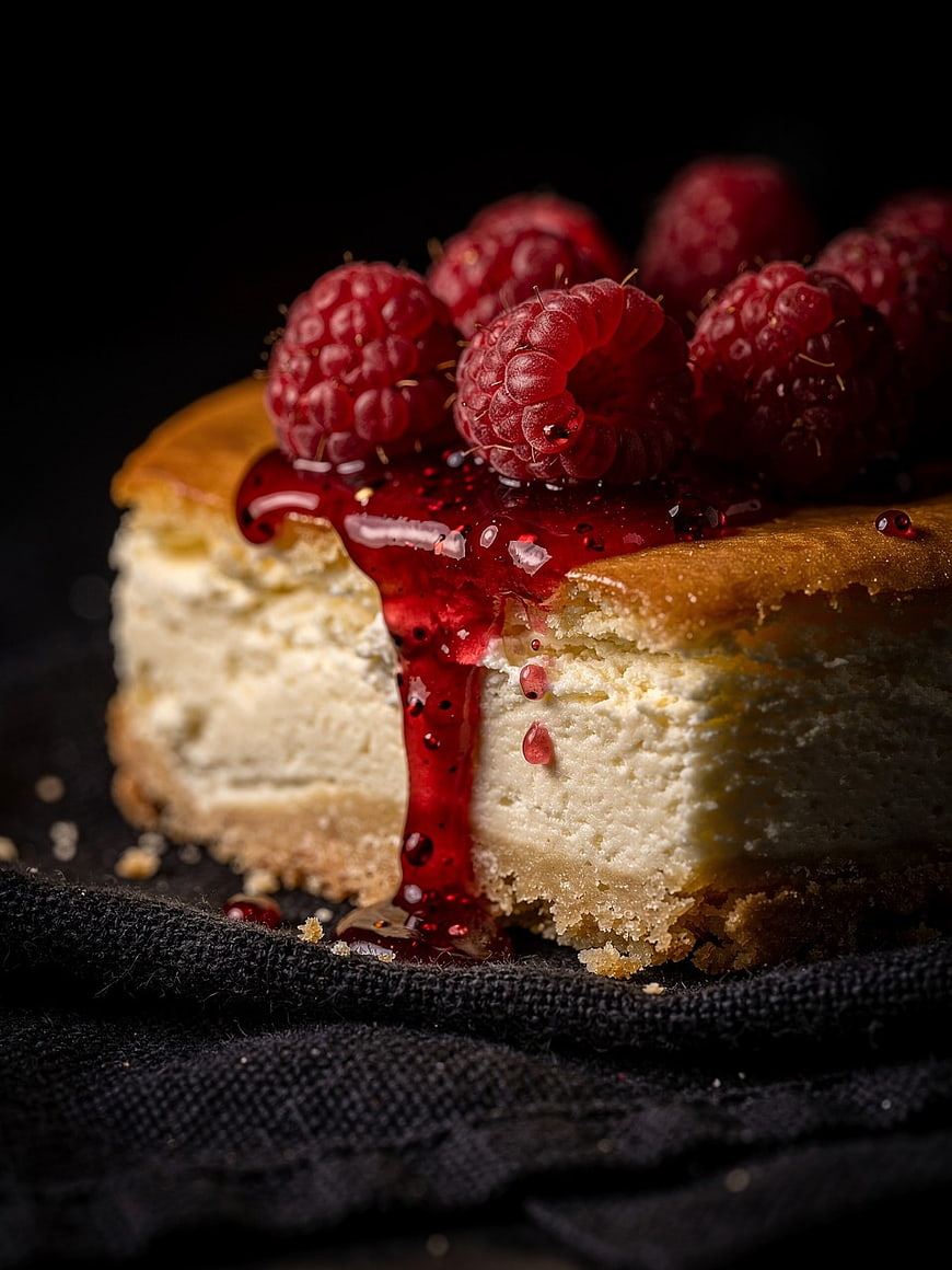 Close-up of Raspberry Cheesecake Slice with Dripping Sauce
