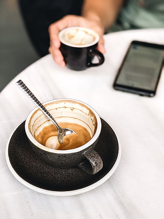 Empty coffee cup with spoon on marble table