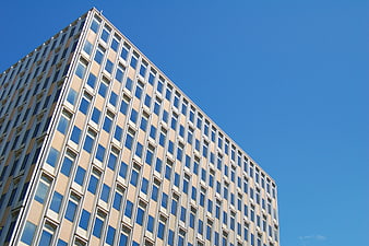Modern office building facade against clear blue sky