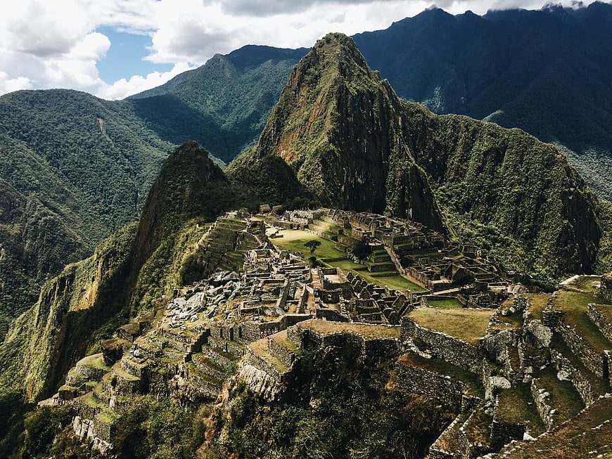 Machu Picchu ruins nestled in lush green mountains