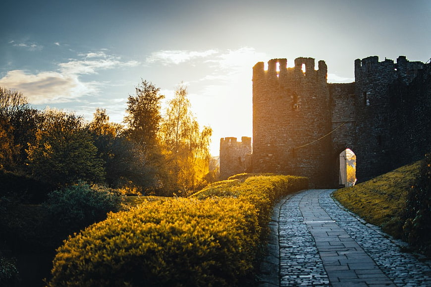Sunlit Stone Castle Ruins with Cobblestone Path
