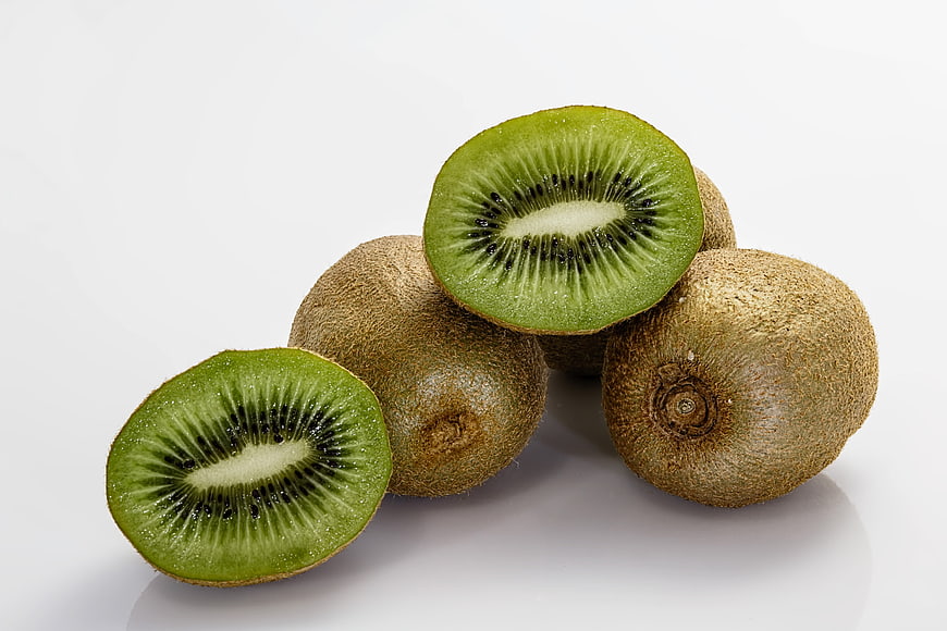 Fresh Green Kiwi Fruit Slices on White Background