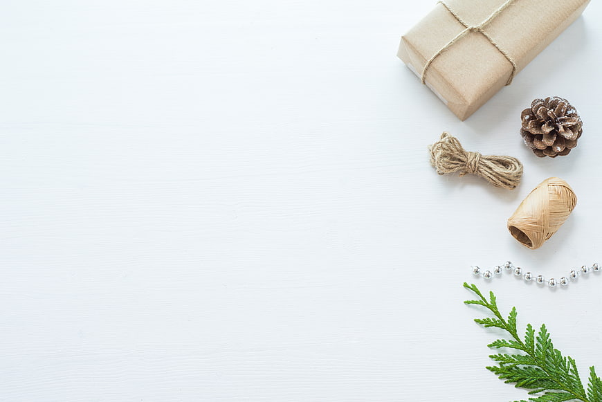 Minimalist Christmas Gift Flat Lay with Pine Cone and Twine