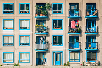 Colorful apartment building facade with blue windows and balconies