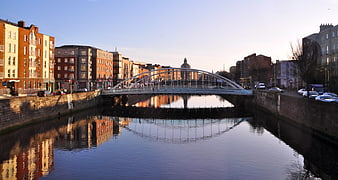 Modern white arch bridge over canal in Dublin city