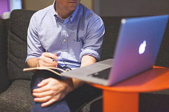 Man working on laptop and notebook in modern office