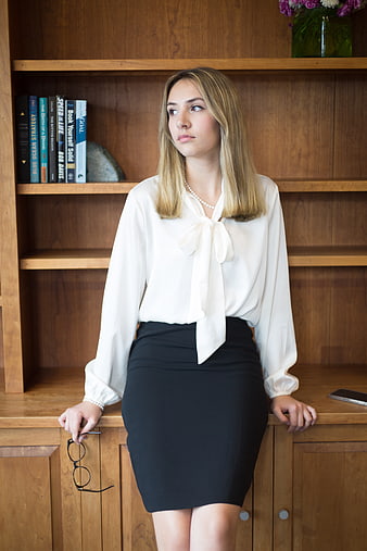 Young Businesswoman in Office with Bookshelf Background