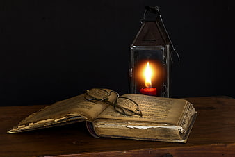 Vintage Book with Glasses and Lantern on Wooden Table