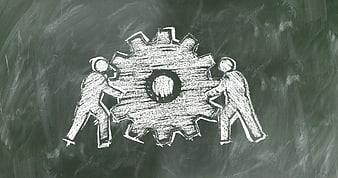 Chalk drawing of teamwork pushing a gear on blackboard