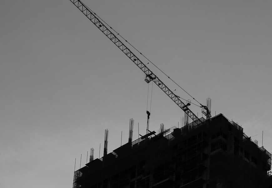 Silhouette of Construction Crane and Building Under Construction