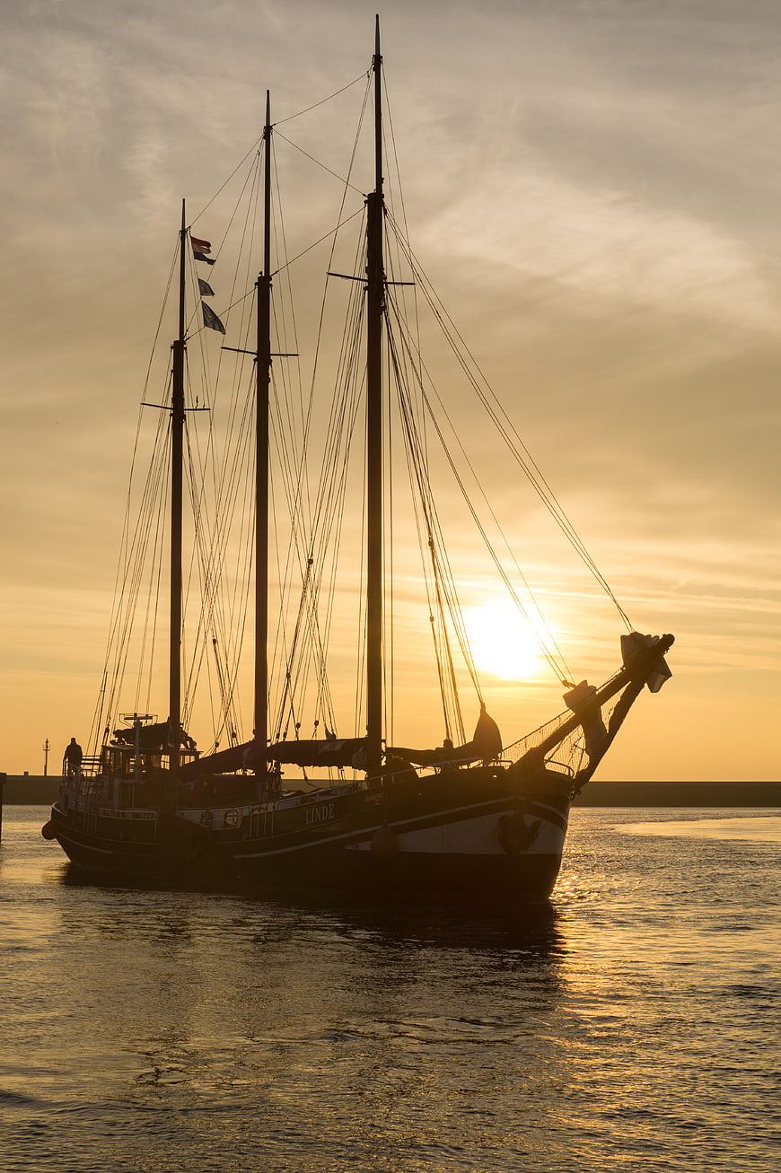 Silhouette of Three-Masted Schooner at Golden Sunset