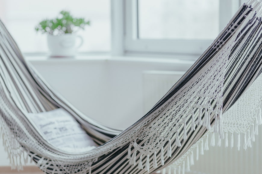 Cozy Striped Hammock with Newspaper in Bright Room