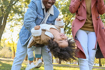Happy African American Family Playing in Park