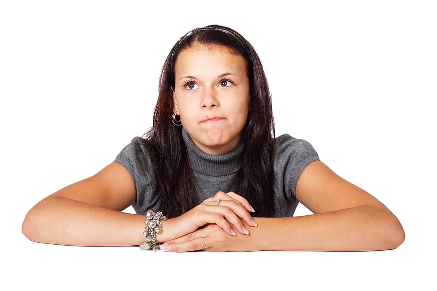Young woman looking up thoughtfully with pensive expression