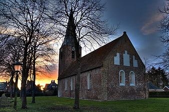 Historic Brick Church at Sunset with Bare Trees