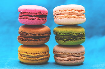 Stacked Colorful French Macarons on Blue Background