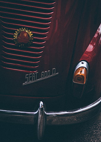 Close-up of vintage red SEAT 600 D car grille and emblem