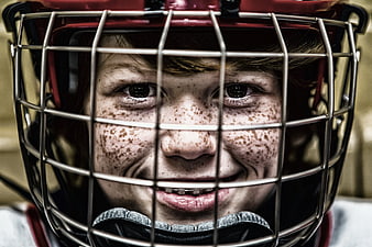 Close-up portrait of smiling young hockey player with freckles