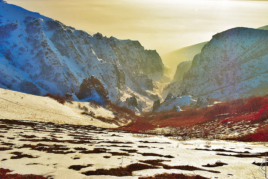 Snowy Mountain Valley with Golden Hour Light