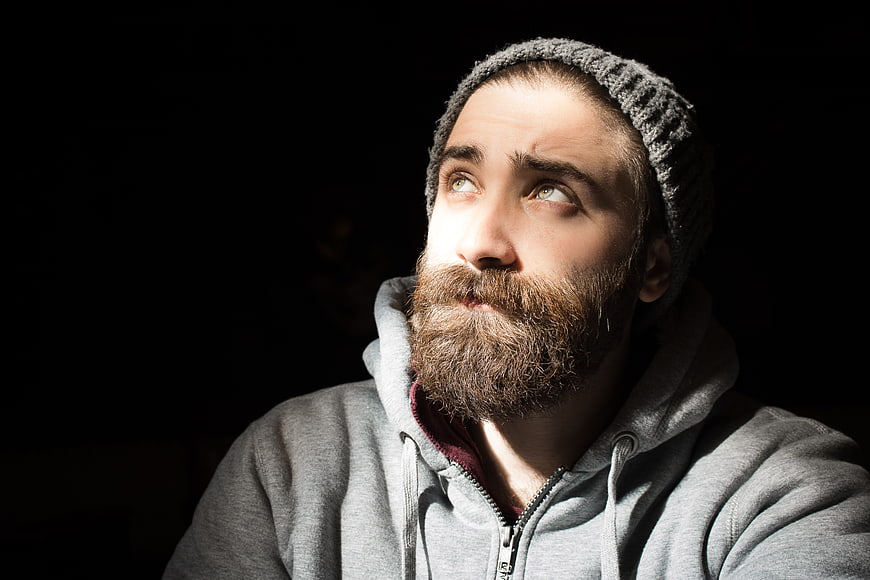 Portrait of bearded man in beanie looking up