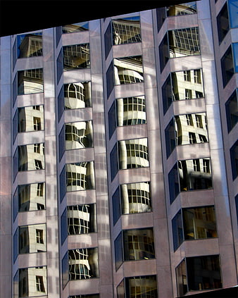Modern building facade with distorted window reflections