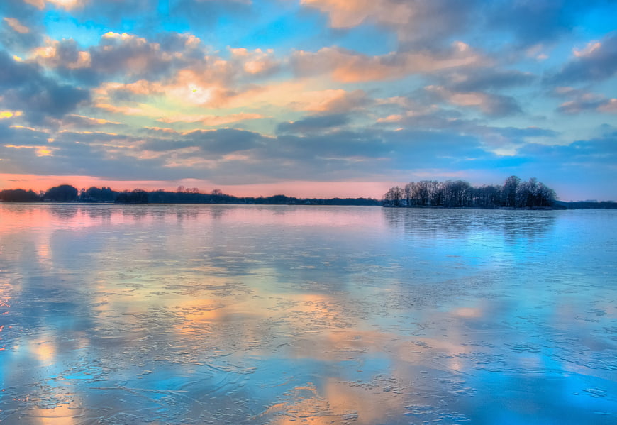 Frozen Lake Sunset with Blue and Orange Sky Reflections