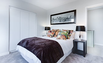 Modern Bedroom Interior With Dark Velvet Throw And Cityscape Art