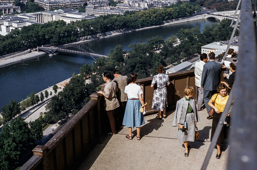 Vintage View of People on Eiffel Tower Balcony Overlooking Paris River